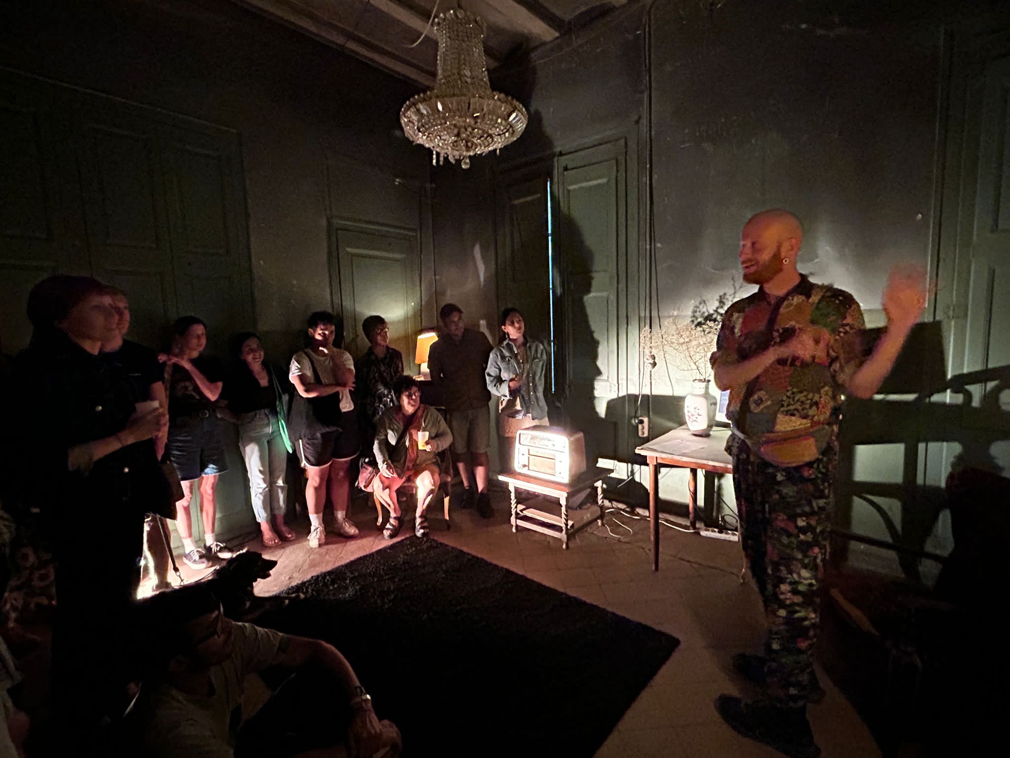Photograph of vitling discussing the installation with a visiting exhibition audience